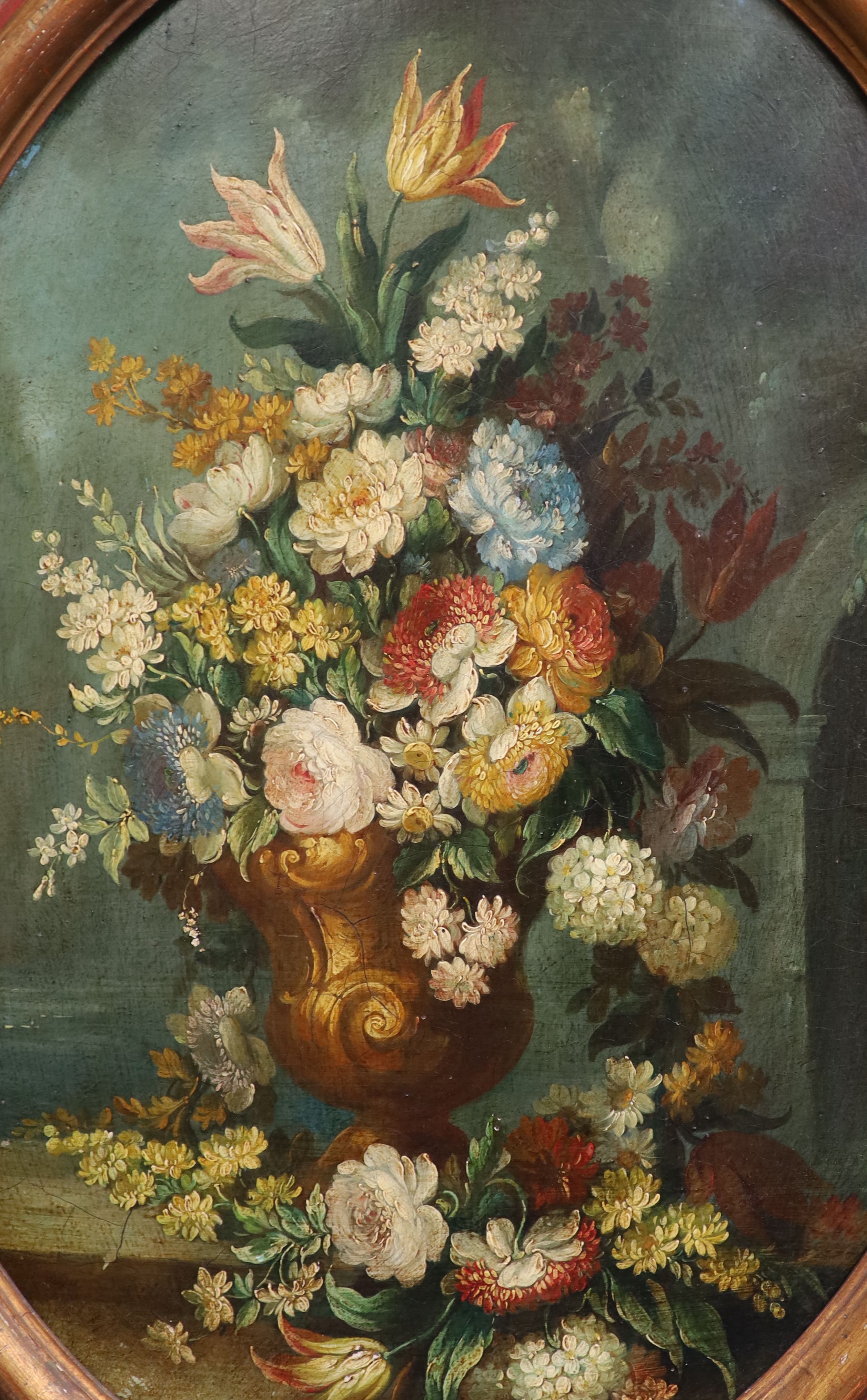 19th century Italian School , Still lifes of flowers in vases, an arch and water beyond, pair of oils on wooden panels, ovals, 65 x 47cm